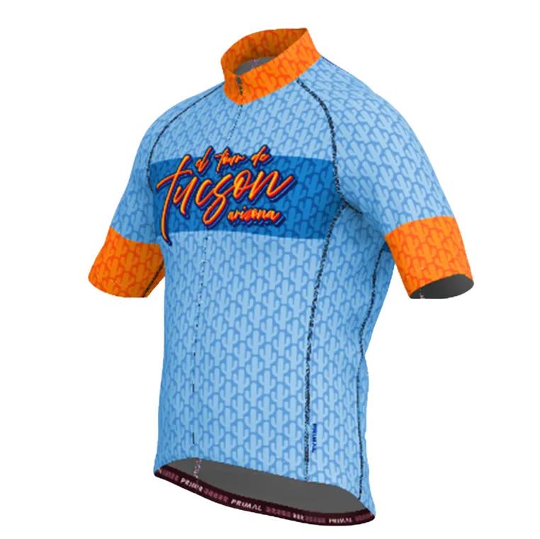 Light blue short-sleeve cycling jersey with orange trim and El Tour de Tucson script across the chest, on white