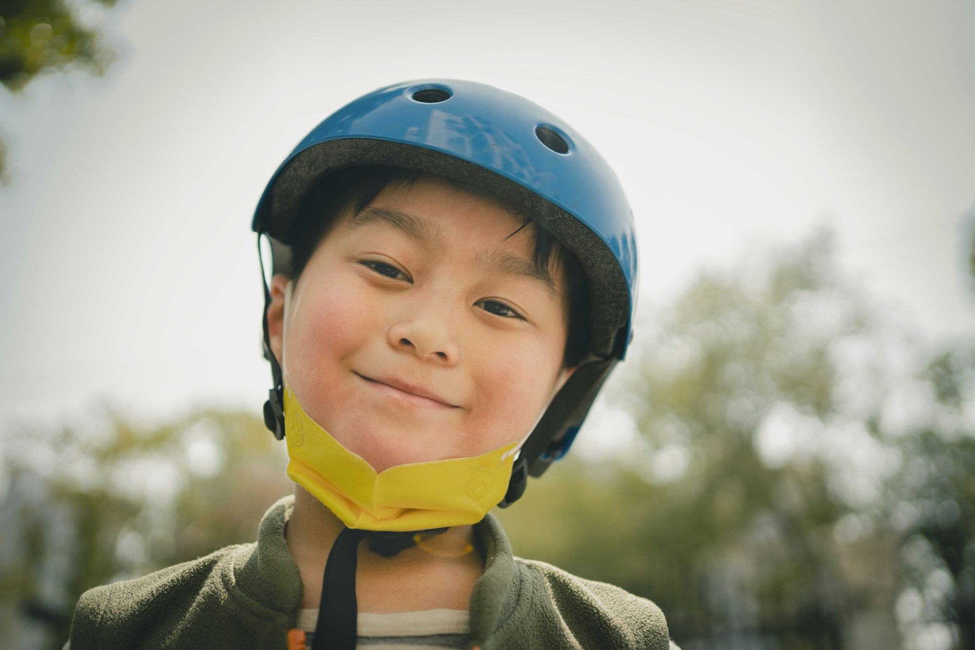 Kids in bike helmets with their bicycles.